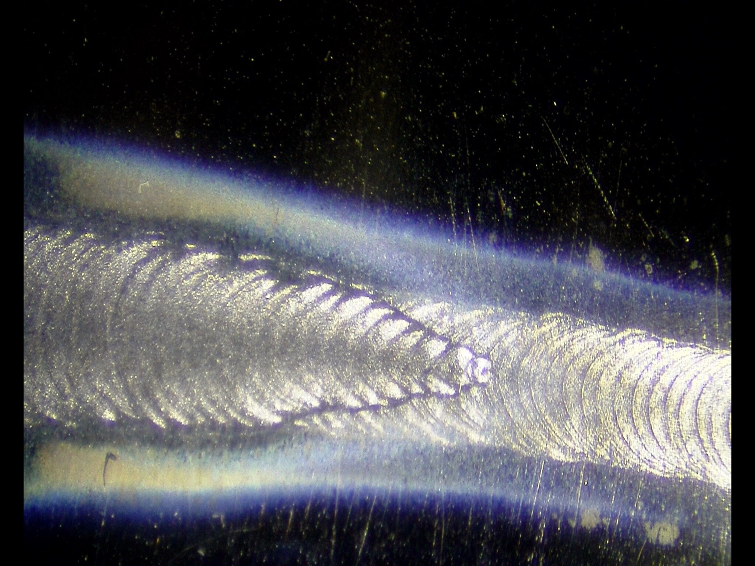 Videoscope image of a weld bead with a tapered weld-tail feature near the center-right